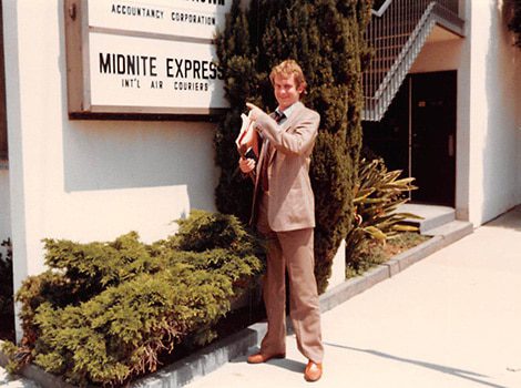 person outside midnite express building in the 1980s