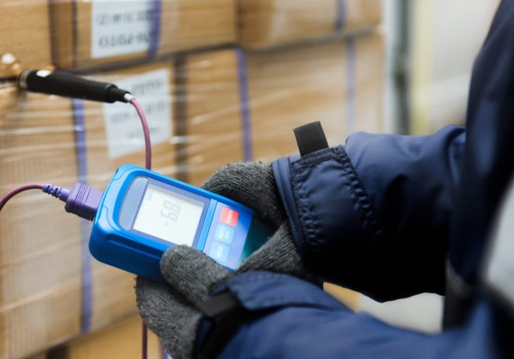 Hand of worker using thermometer